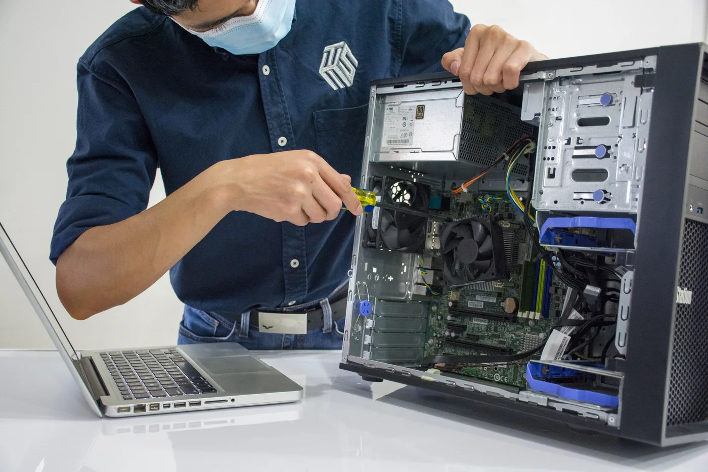 Technician installing and maintaining computer equipment